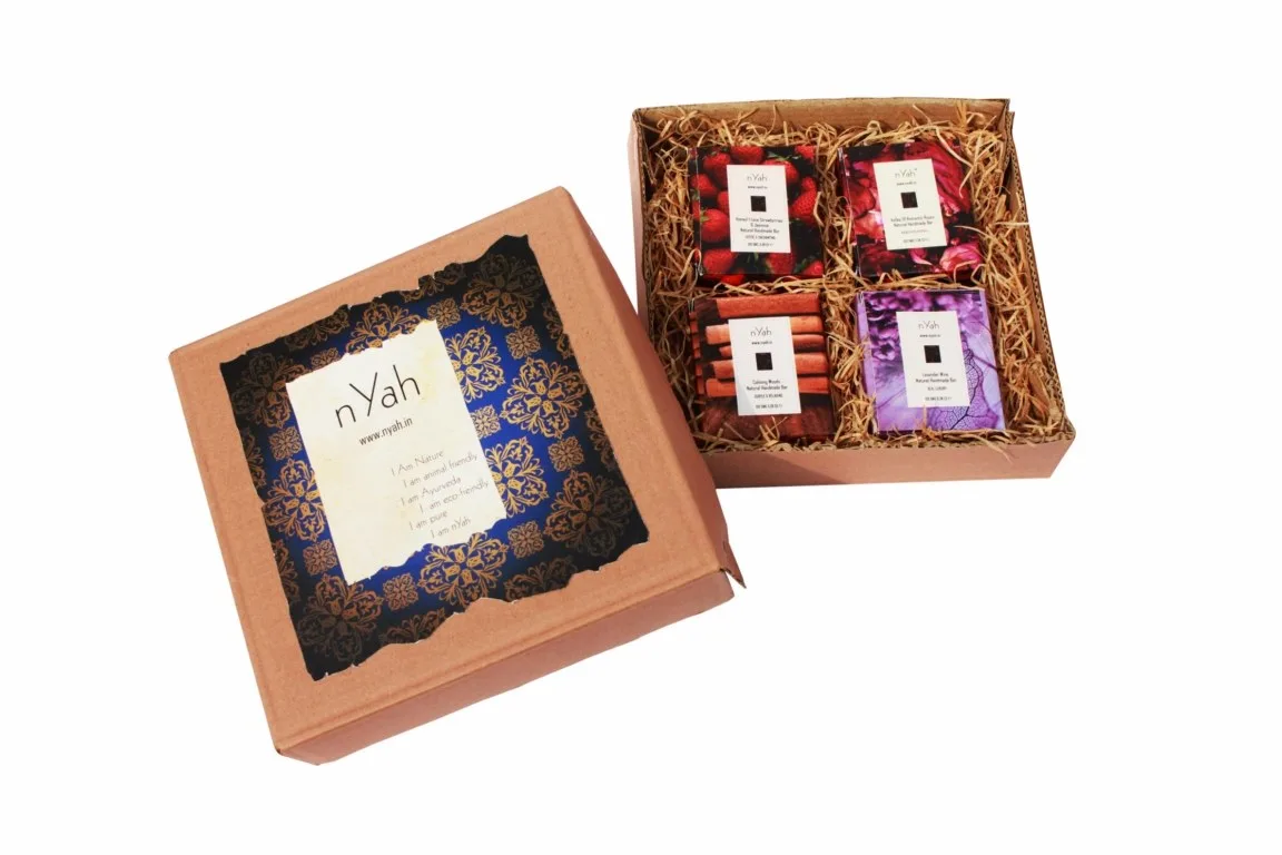 Nyah Large Royal Handmade Box Soaps – 2 × 100 g, Open decorative box with two round soap-like products and ornate blue/gold-style lid artwork.