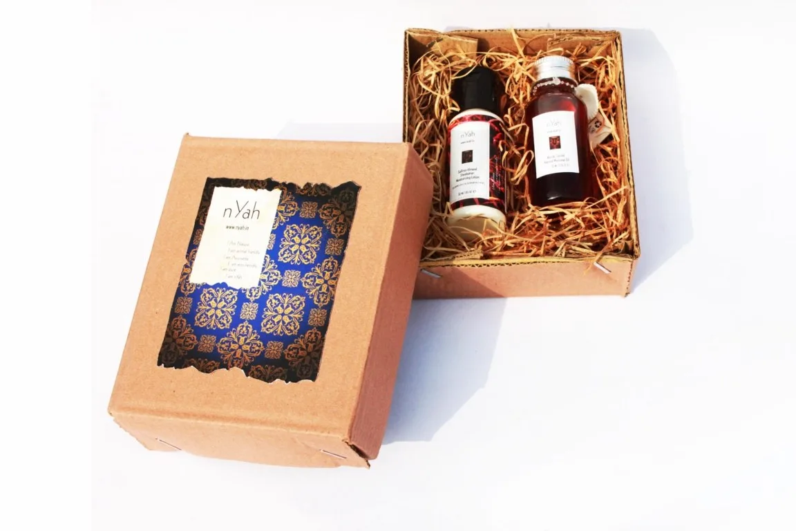 Nyah Small Royal Handmade Box – Massage Oil 70 ml & Lotion 55 ml, Open decorative box with two bottles and ornate blue/gold-style lid.