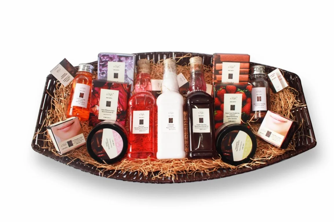 Nyah Boat Basket Gift – Best of Nyah (190 ml), Boat-shaped woven-look basket with assorted boxed and bottled personal-care items; exact item count and individual sizes need confirmation.