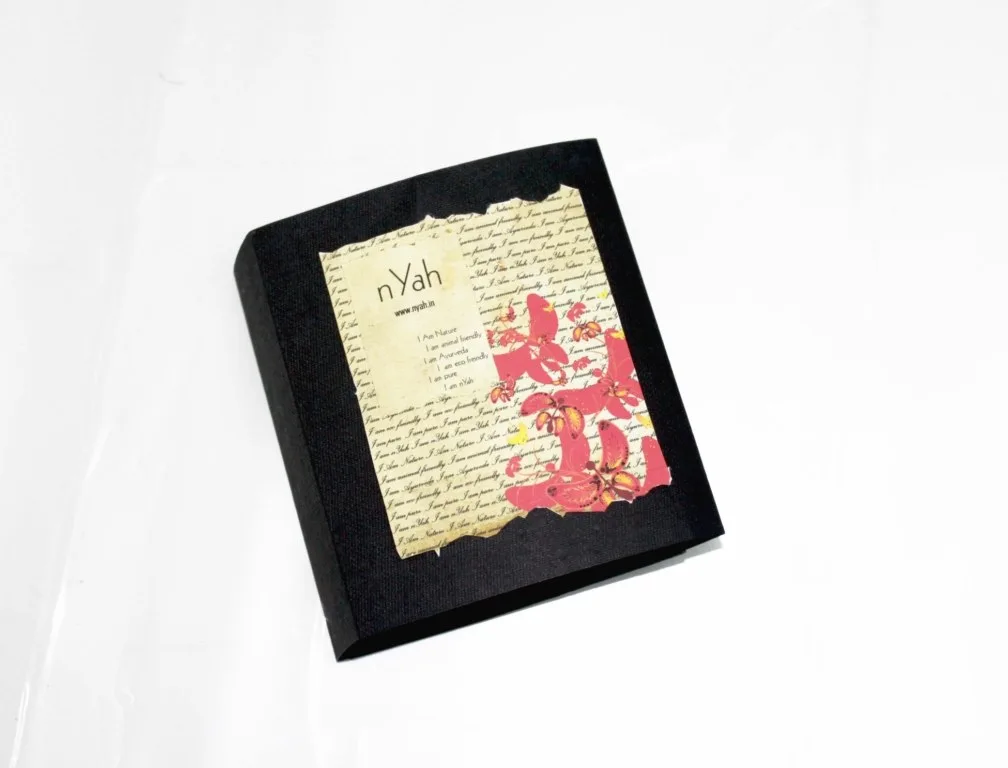 Nyah Small Book Gift Soap – 100 g, Small black book-style presentation box with decorative cover artwork.