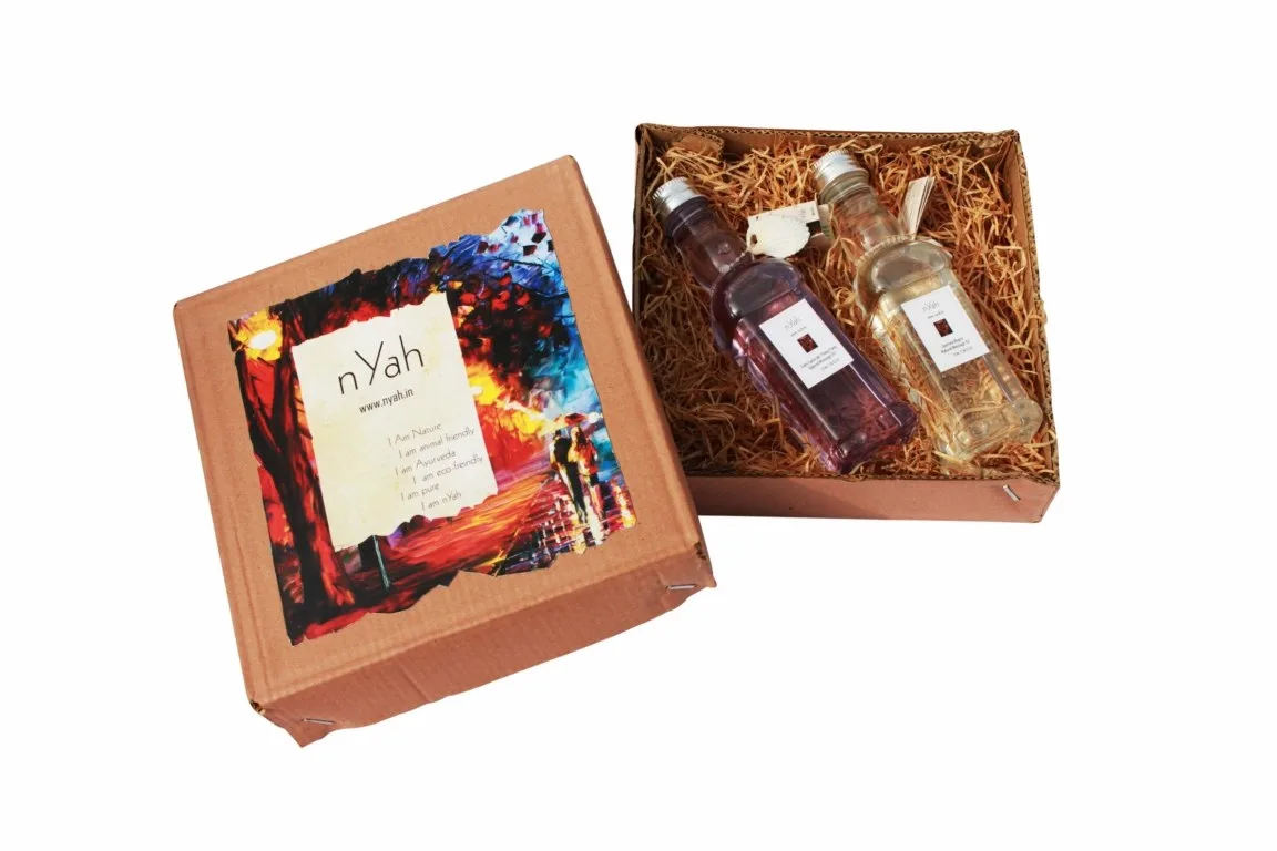 Nyah Large Romantic Handmade Box Massage Oils – 2 × 190 ml, Open decorative box with two bottles and romantic floral artwork on the lid.