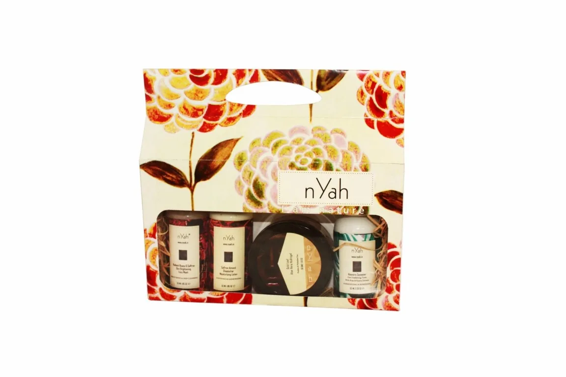 Nyah Small Floral Gift Facial Care – 4-piece, Floral illustrated carton with four visible items, including small bottles and round containers.